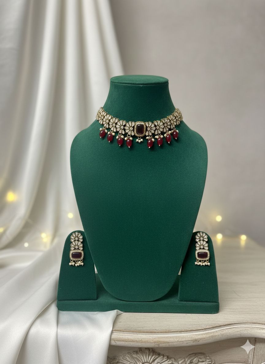 Jewelry set with a necklace and earrings on a green mannequin bust against a white curtain background.