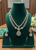 Jewelry set with necklace and earrings on a green mannequin bust