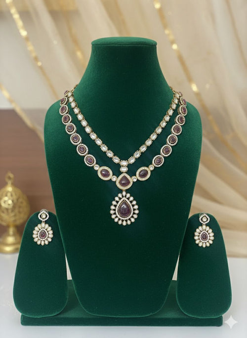 Jewelry set with necklace and earrings on a green velvet stand against a decorative background.